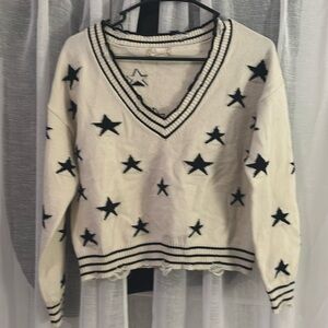 Cute soft crop sweater with navy stars the neck and bottom hem has some fraying